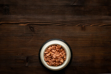 Bowl of biscuits for pets - food in a shape of heart, top view