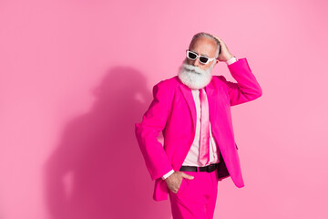 Photo of serious old cool man gentleman boyfriend touch hair head wear sunglass stylish pink suit isolated over pastel color background