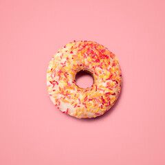 Colorful, sprinkles and above with donut in studio for unhealthy diet, nutrition and sweet treat....