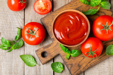 Fresh cherry tomatoes and fresh green basil on a textured background. Tomato sauce. Vegan. Ingredients for salad. Organic food. Place for text. Copy space.