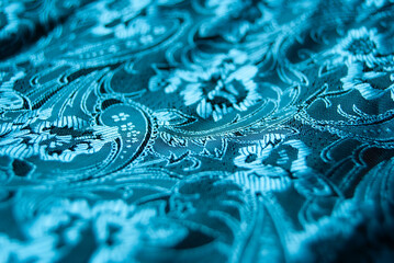 turquoise silk with flower patterns, creating a delicate and elegant texture.