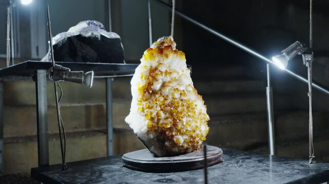 A striking studio photo of a large amber crystal illuminated by spotlights, showcasing its natural beauty and texture. Artistic Display of Amber Crystal Under Spotlights