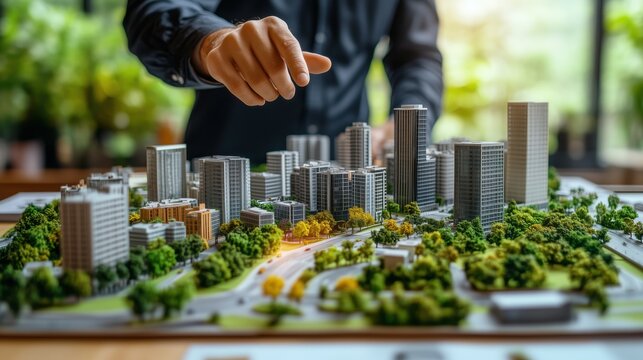 Hand Adjusting City Model with Skyscrapers and Roads. Hand adjusting a detailed model of a city featuring skyscrapers, roads, and green spaces, representing urban planning and development.
