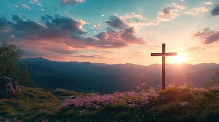 Silhouette of a cross on a mountaintop at sunset.