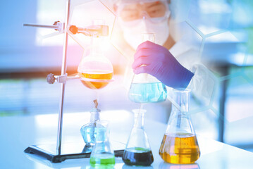 Research and development scientist with equipment and science experiments ,laboratory glassware containing chemical liquid for design or decorate science or other your content,selective focus.