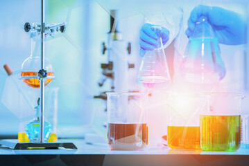 Research and development scientist with equipment and science experiments ,laboratory glassware containing chemical liquid for design or decorate science or other your content,selective focus.
