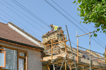 Workers remove chimney roof. London, UK, 29 July 2024