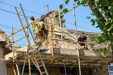 Workers remove chimney roof. London, UK, 29 July 2024