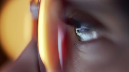 Close-up of a developer in glasses intensely working on a computer. Reflections of code and analytics in the glasses highlight expertise in cybersecurity and software development. © wedmoments.stock