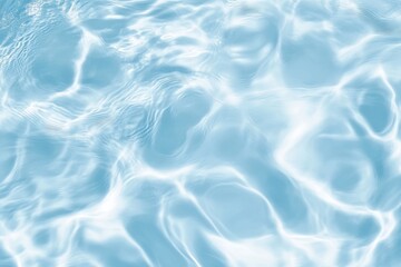 A mesmerizing image of rippling blue water reflecting light, creating an abstract and calming atmosphere.