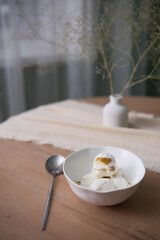 A Delightful Serving of Creamy Ice Cream on a Beautifully Crafted Wooden Table with Lovely Decor