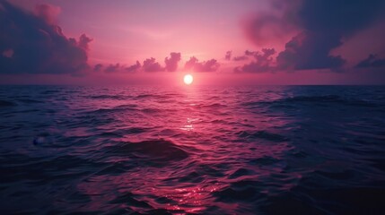 Fototapeta premium A sunset over the ocean with the sky transitioning from pink to deep indigo