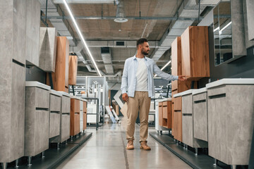 Furniture and cabinets. Man is in the hardware shop