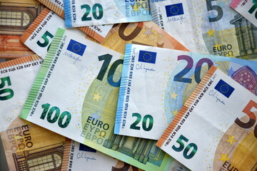Many european euro money bills in chaotic arrangement. Pile of eur banknotes with different colors and condition