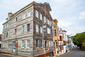 historical rural wood siding houses standing on the road, prince islands, adalar, istanbul