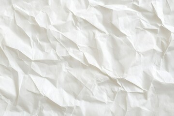 Fototapeta premium Crumpled white paper texture with uneven creases and folds, creating a rough and organic appearance.