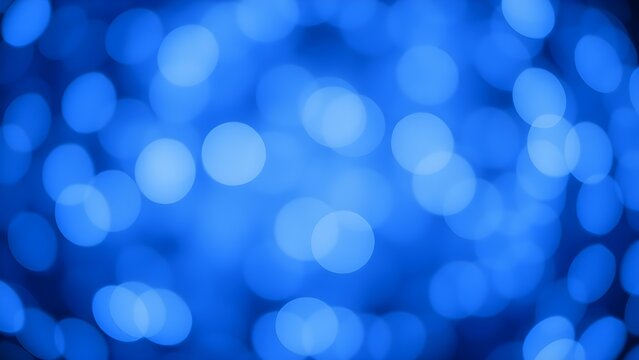 Soft blue bokeh lights create an abstract background at night