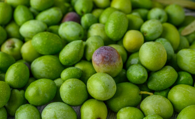 freshly picked green olives as background
