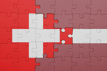 Fototapeta premium puzzle with the colourful national flag of latvia and flag of switzerland.