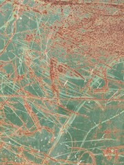Rusted and Scratched Painted Metal Background in a Rust and Blue Green Color