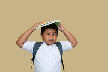 adorable asian fat boy smiling happily wearing indonesian student uniform isolated on brown background, Portrait of little boy elementary school, Back to school. Ready go to school