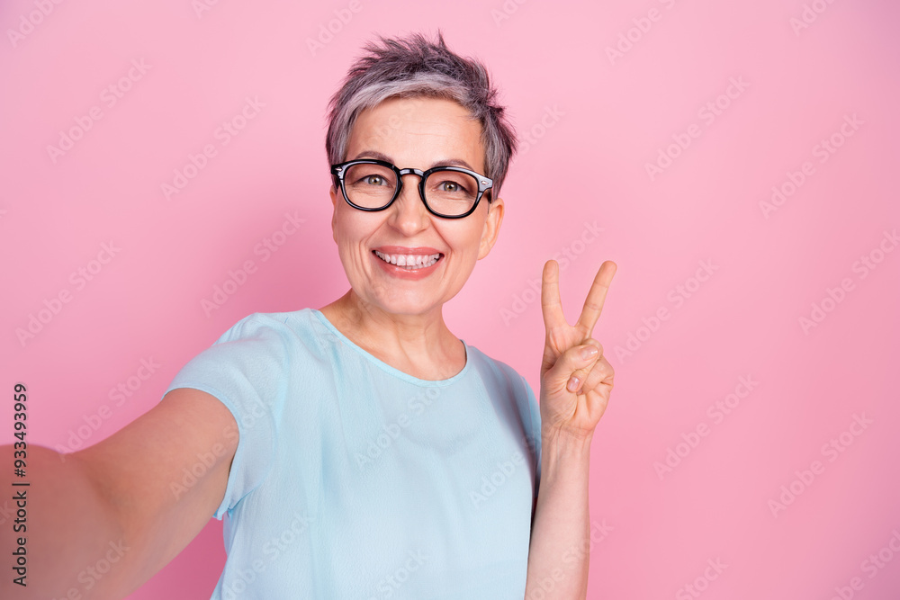 Sticker portrait of nice aged lady selfie v-sign blue t-shirt isolated on pink color background