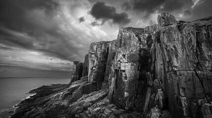 Black and white photo of rocky cliffs overlooking the sea 