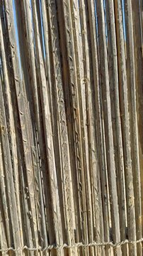 Wooden fence with rough texture made from natural materials and wood branches. This cultural wooden structure highlights region heritage and traditional design. Authentic craftsmanship