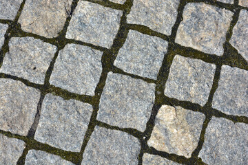 Construction, materials and equipment for construction work. Beautiful stones, gray cobblestones, gray stones laid out textured on the ground, masonry with stones.