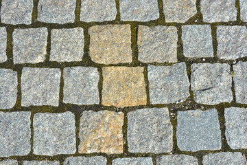 Construction, materials and equipment for construction work. Beautiful stones, gray cobblestones, gray stones laid out textured on the ground, masonry with stones.