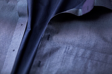 Close up of dark Men's shirt. Soft focus. Copy space.