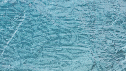 Arabic calligraphy wallpaper on a wall with a blue background and old paper interlacing. Translate...