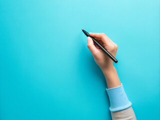 Top above overhead close up first person view photo of girl's right hand holding black pen starting to write isolated over blue color pastel background