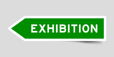 Green color arrow shape sticker label with word exhibition on gray background