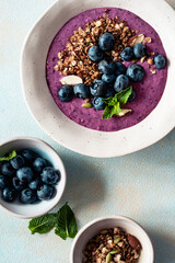 Healthy summer smoothie bowl with blueberries and granola, directly above