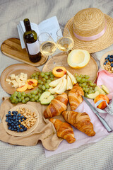 Aesthetic picnic. Natyarmort croissant, fruit, melon, grape, apple and wine. Summer picnic with fresh fruit and croissants in the garden.