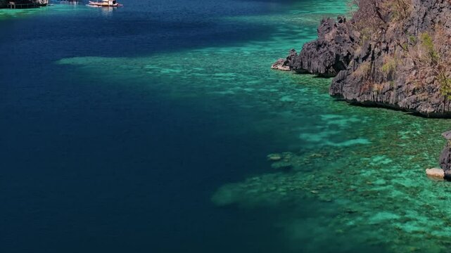 Establishing aerial view of tropical paradise exotic island surrounded by crystal turquoise sea and sail boats. Travel video of Coron island Philippines, untouched nature on sunny summer day