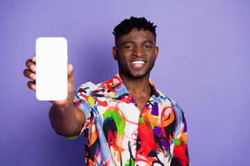 Photo portrait of pretty young male hold device show white screen wear trendy colorful outfit isolated on violet color background