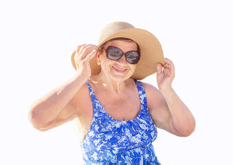 Senior (elderly) woman (over age of 50) in swimsuit, hat and sunglasses relaxing in resort. Retired female enjoying summer. Isolation on white background..