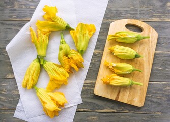 Preparing stuffed zucchini flowers in batter with mozzarella. Kitchen scene, soft focus