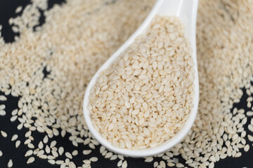 White roasted sesame seeds in a spoon