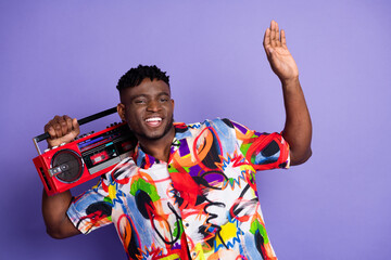 Photo of nice young man carry boombox wear shirt isolated on violet color background