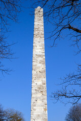 The Masonry Obelisk between bare tree branches, roman empire, byzantium period, in the Hippodrome...