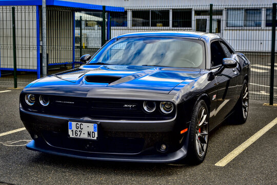 Roche-la-Moli&egrave;re, France - July 2nd 2023 : Car show. Side view on a black Dodge challenger srt hellcat widebody.