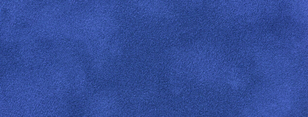 Navy blue matte background of suede fabric, closeup. Velvet texture of seamless sapphire textile, macro.