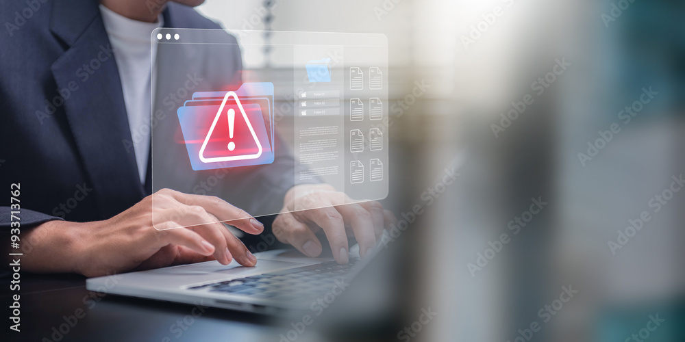 Leinwandbilder Cybersecurity and cybercrime. Person working on a laptop with a projected cybersecurity alert on a virtual file and document interface, highlighting data breach risk, hacking and spam.