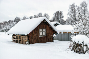 garden in winter, covered with snow, fruit trees, garden house and garden accessories