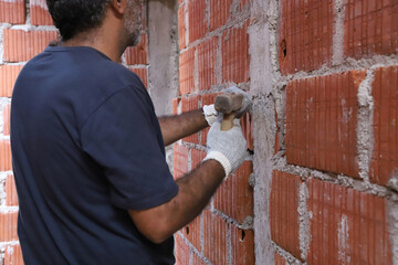 
Bricklayer working on construction site. Construction worker.