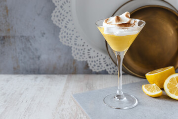 Citrus cream in tall glass with lemon slices and caramelized egg whites frosting