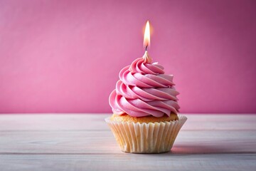 A close up view of a pink birthday cupcake with creamy icing and a single lit candle against a pink backdrop, candle, party, cream, bakery, background, close-up, treat, tasty, candlelight